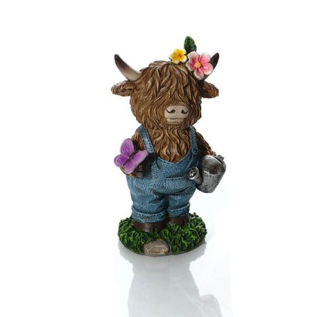 figurine of Highland cow in overalls on a white background