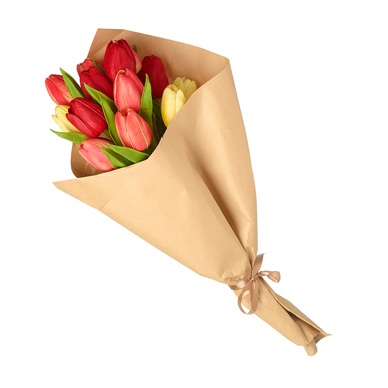 A bunch of artificial tulips with red, yellow, and pink petals, wrapped in brown paper with a ribbon.