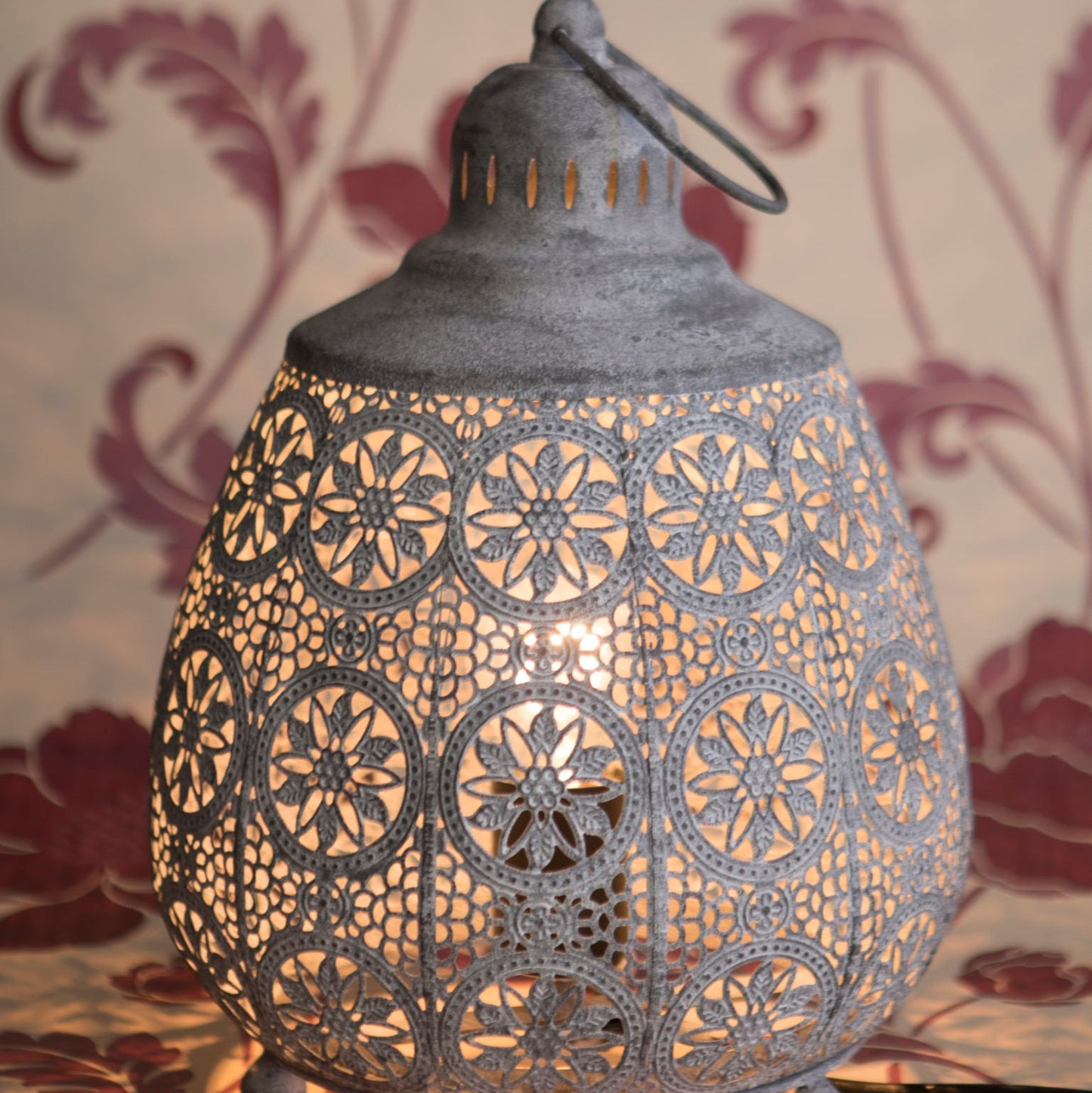 Decorative lantern with intricate patterns on a floral background