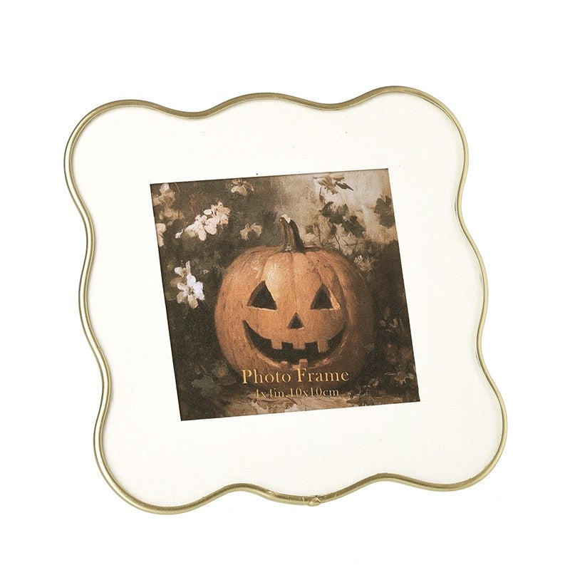Decorative gold wavy edge photo frame on a white background