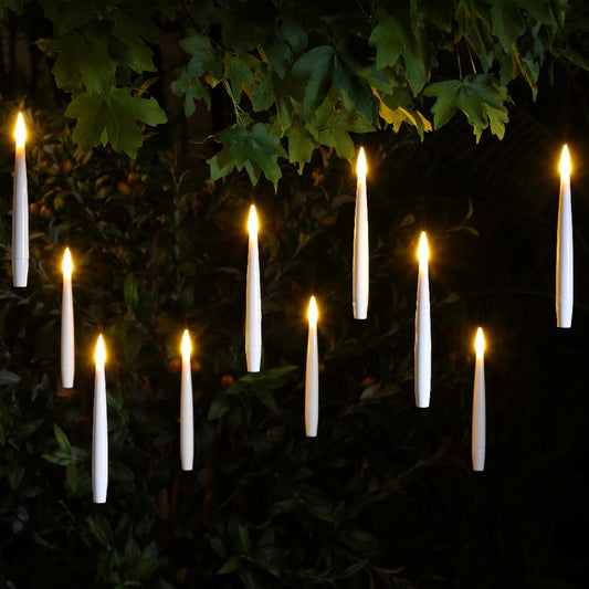 10 led candles floating in the air from a green leafy tree