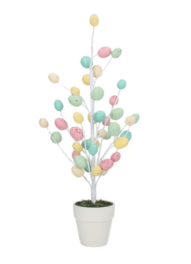 A potted twig tree with pastel rustic speckled eggs, placed in a white ceramic pot.