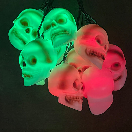 skull lights with the LED's on which are red and green clumped together on a plain background to show off the lights clearer
