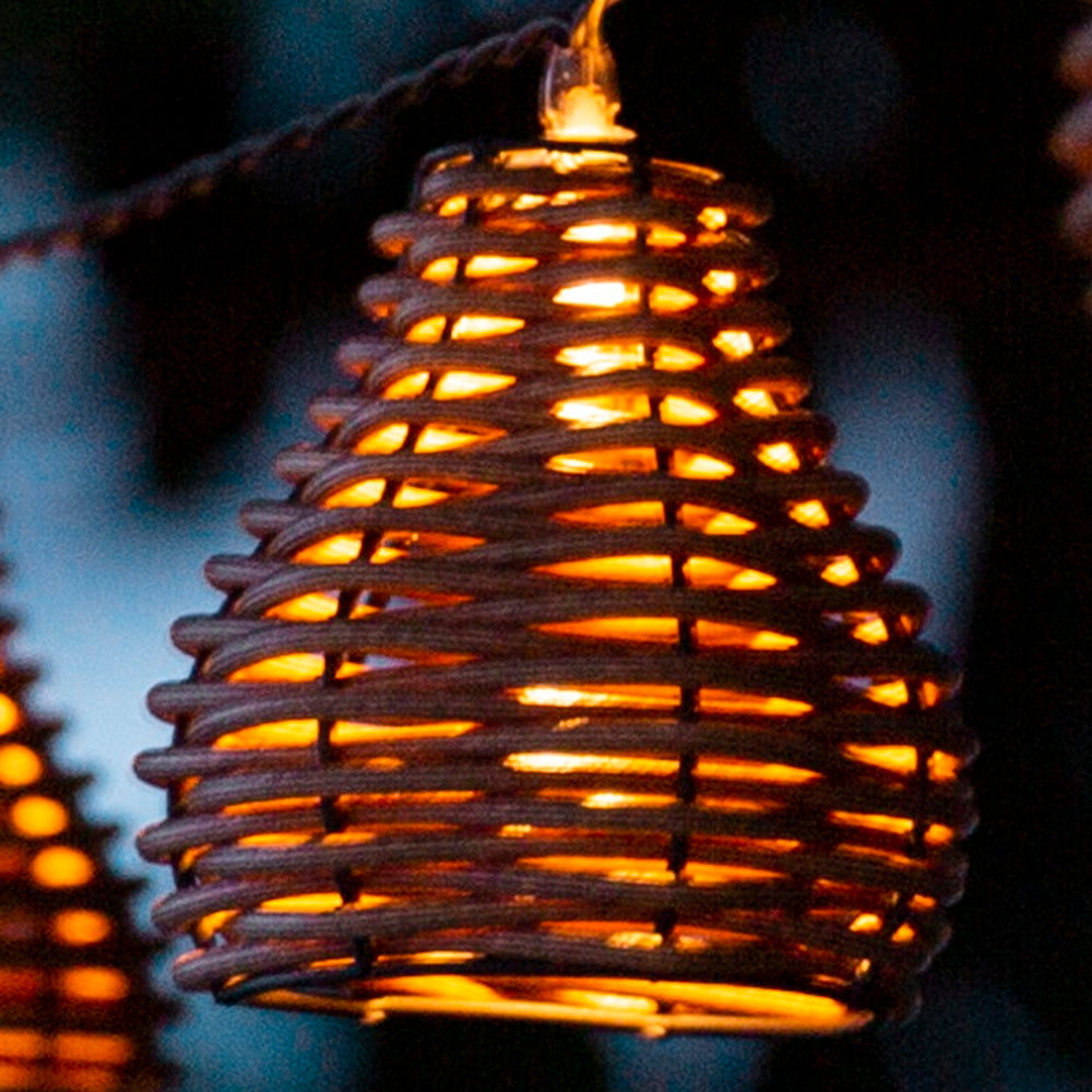 Wicker lantern with warm glow against a dark background