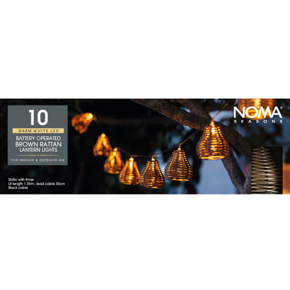Noma Seasons battery-operated brown rattan lantern lights with packaging on a white background