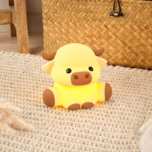 Highland cow silicone night light on a woven mat with a woven basket in the background