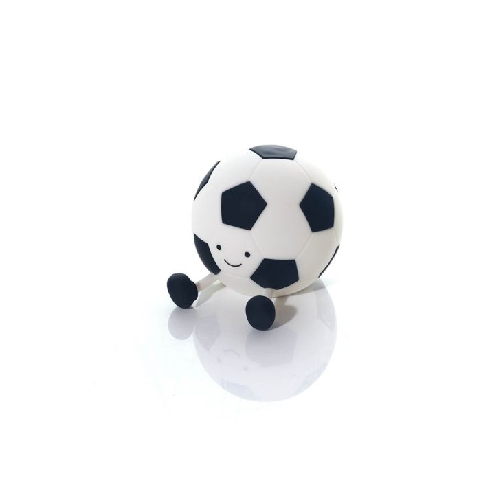 Soccer ball-shaped night light with a face on a white background