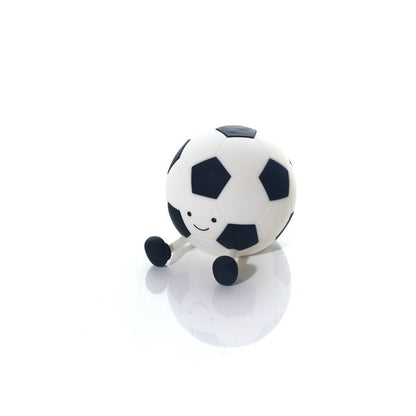 Soccer ball-shaped night light with a face on a white background