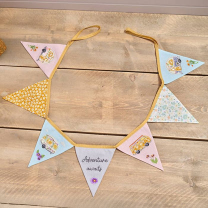 Decorative bunting with colorful triangles on a wooden surface