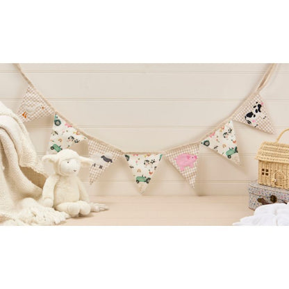 Children's room with a toy, blanket, and decorative banner on a wooden floor.