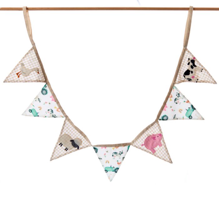 Triangle-shaped fabric flags with animal patterns hanging on a wooden rod against a white background