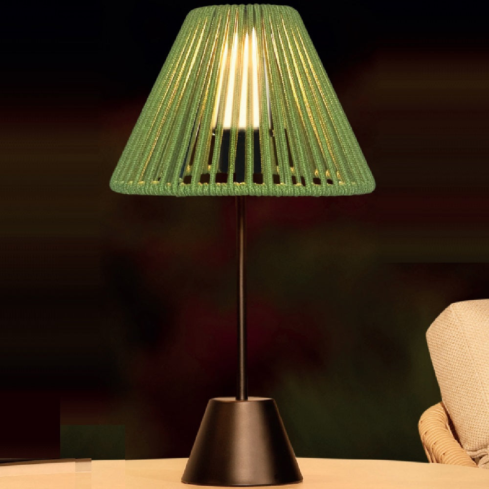 Green table lamp with a dark background