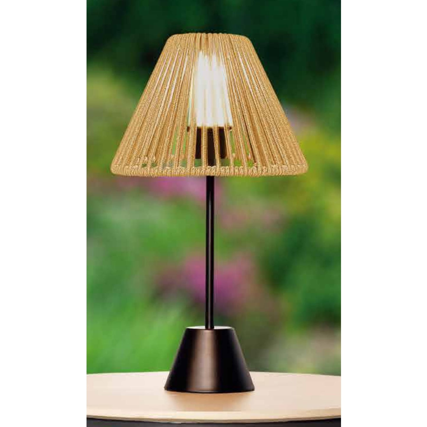 Table lamp with a woven shade on a blurred natural background