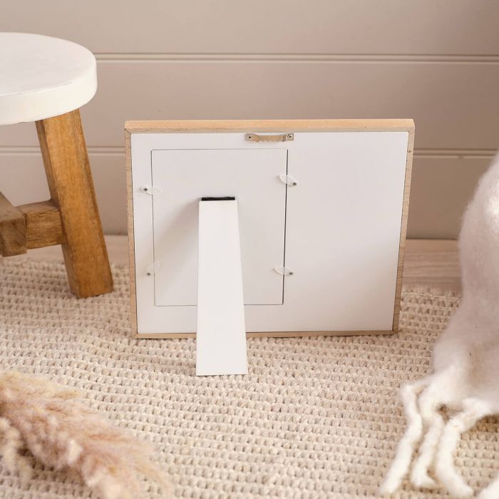 back of Small wooden photo frame with on a beige carpet