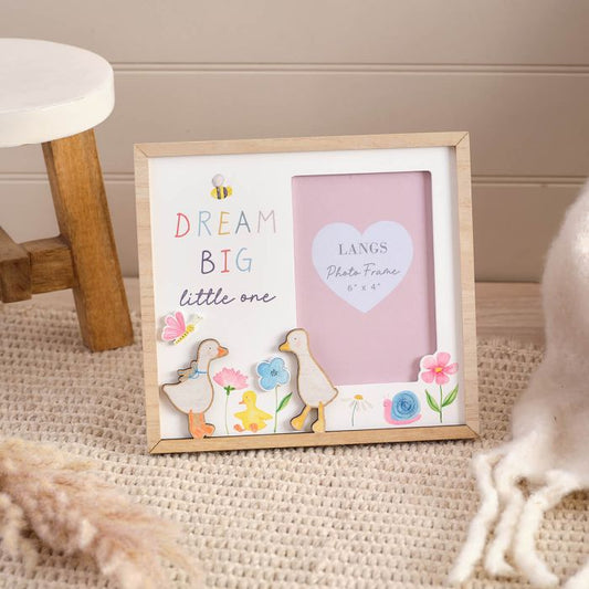 Decorative photo frame with 'Dream Big little one' text and geese on a textured surface.