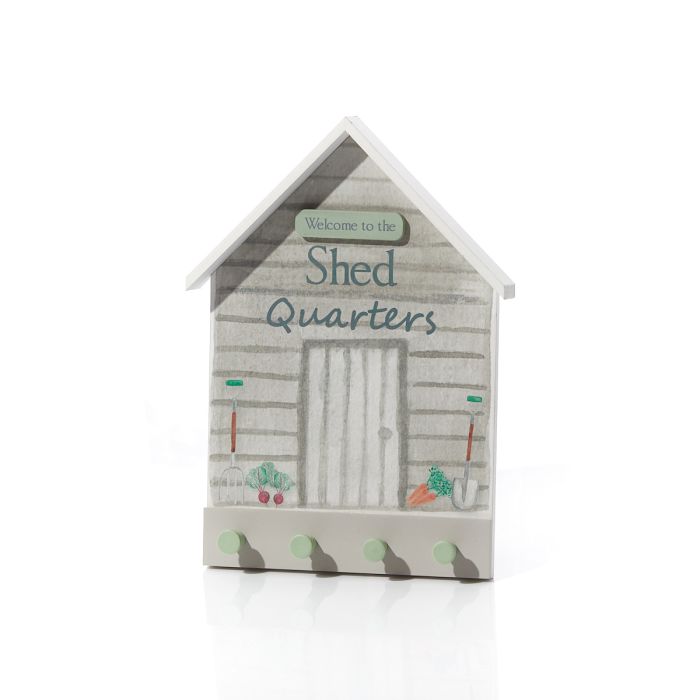Decorative sign shaped like a shed with 'Welcome to the Shed Quarters' text on a white background