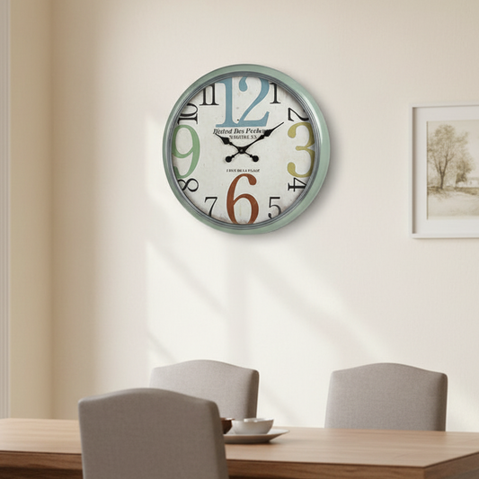 Decorative wall clock with colorful numbers in a room with a table and chairs.