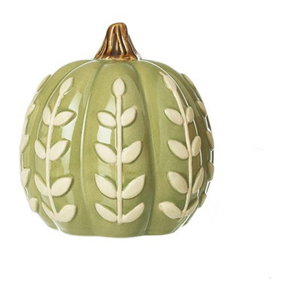 A decorative ceramic pumpkin in sage green with raised cream leaf patterns and a small gold-toned stem, shown on a plain white background.
