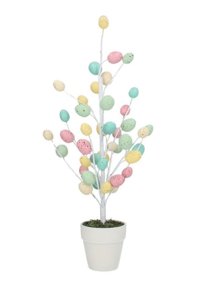 A potted twig tree with pastel rustic speckled eggs, placed in a white ceramic pot.